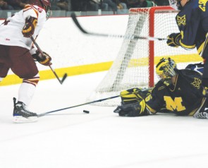 Go for the Gold: Senior Casey Haines (#6) shoots for the goal during Saturday’s game against the Michigan Wolverines. Haines made the first goal of the game, shooting the puck right over the goalie, and the Bulldogs went on to win the game 3-2. Photo By: Kate Dupon | Photo Editor