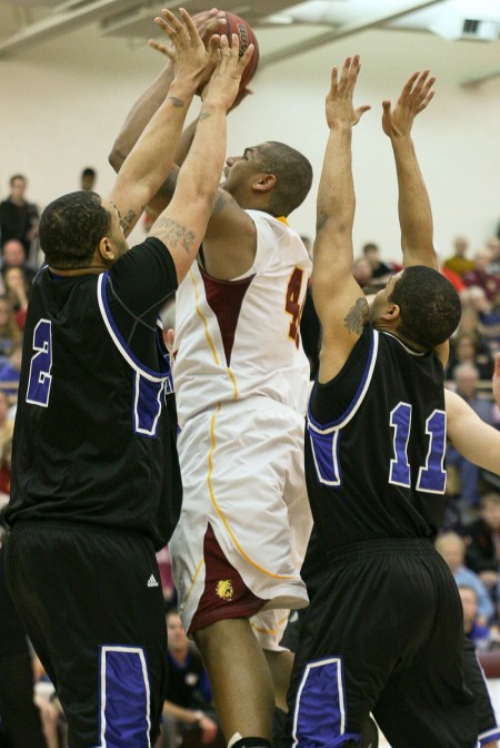 Closing the Season: Justin Keenan, senior pushes past two Grand Valley defenders during a game in the 2010-11 season. The Bulldogs had an overall record of 24-8 at the end of the season. Torch File Photo Closing the Season: Justin Keenan, senior pushes past two Grand Valley defenders during a game in the 2010-11 season. The Bulldogs had an overall record of 24-8 at the end of the season. Torch File Photo